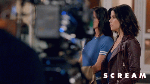 Two Women Standing with Scream Text