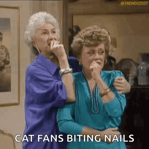 Two Women Talking About Cat Fans Biting Nails