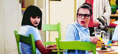 Two Women Talking At Table GIF