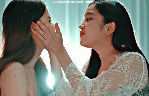 Two Women Touching Faces With Sunset and the Moon