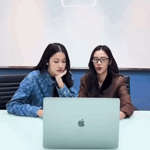 Two Women Using Apple Laptop
