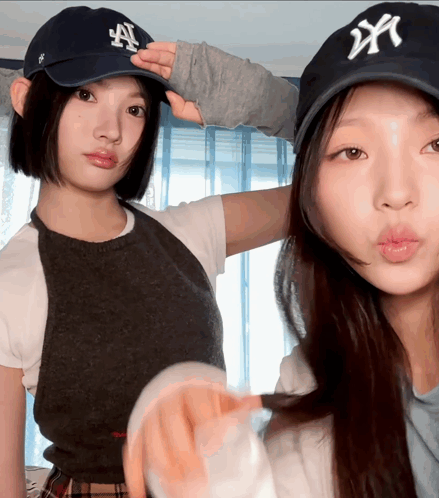 Two Women Wearing NY Hats