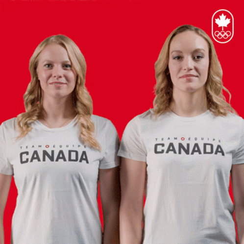 Two Women Wearing White Shirts That Say Canada On Them GIF