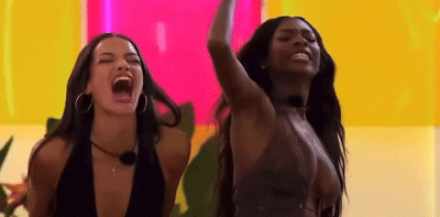 Two Women With Open Mouths And Raised Arms GIF