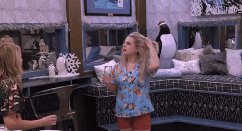 Two Women With Penguin On Wall GIF