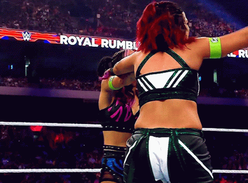 Two Women Wrestling in a Ring Saying Royal Rumble
