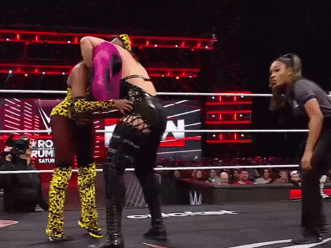 Two Women Wrestling In A Ring With The Word Saturn On The Wall Behind Them GIF