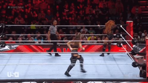 Two Women Wrestling in Ring With Referee WWERAW