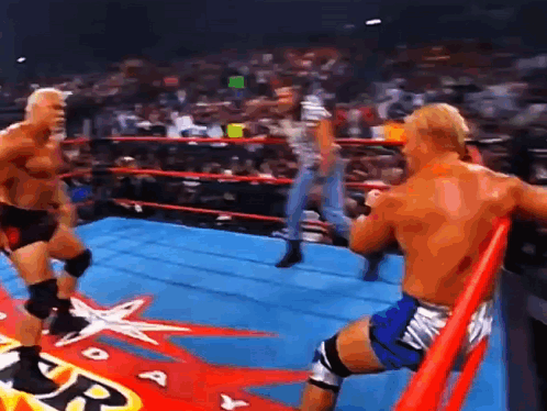 Two Wrestlers Are Fighting In A Ring With A Star On The Floor . GIF