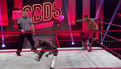 Two Wrestlers Are In A Ring With A Referee In Front Of A Screen That Says Against All Odds Saturday GIF