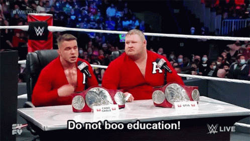 Two Wrestlers Are Sitting At A Table With The Words Do Not Boo Education GIF