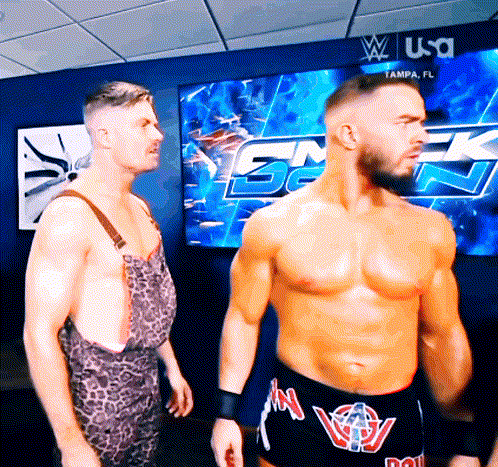 two wrestlers are standing in front of a screen that says tampa fl
