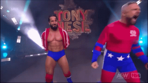Two Wrestlers Are Standing In Front Of A Sign That Says Tony Jesse GIF
