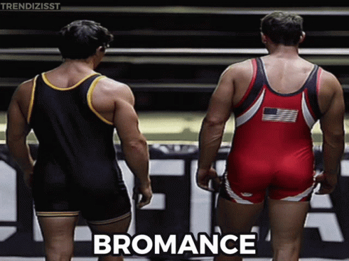 Two Wrestlers Are Standing Next To Each Other And The Word Bromance Is On The Bottom Right GIF