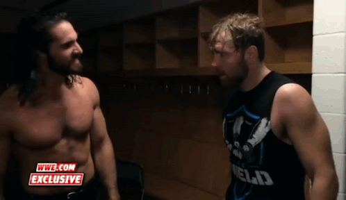 Two Wrestlers Are Standing Next To Each Other In A Locker Room With A Wwe.com Exclusive Logo On The Bottom GIF