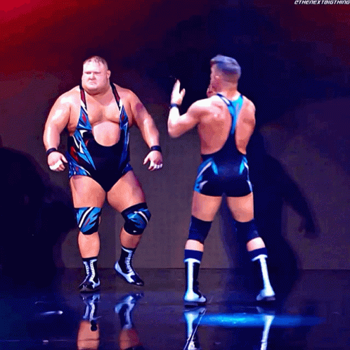 Two Wrestlers Are Standing Next To Each Other With The Hashtag Thenextbigthing GIF
