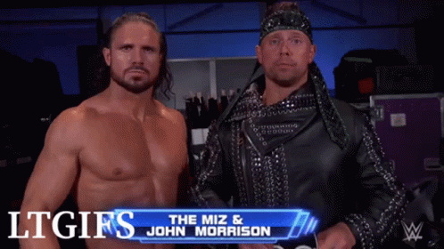 Two Wrestlers Are Standing Next To Each Other With The Miz And John Morrison Written On The Screen Behind Them GIF