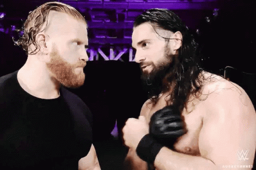 Two Wrestlers Beside Sign Saying nxtl