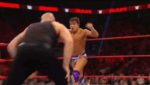 Two Wrestlers Fighting In Ring With Referee GIF