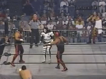 Two Wrestlers Fighting in Ring With Referee