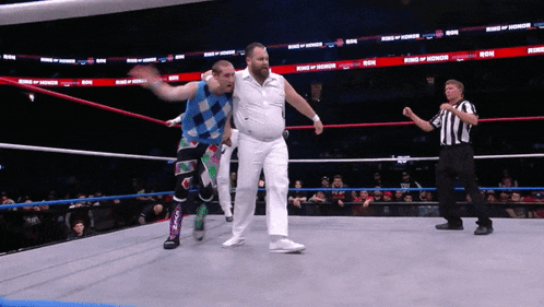 Two Wrestlers In A Ring With The Words King Of Honor On The Walls GIF