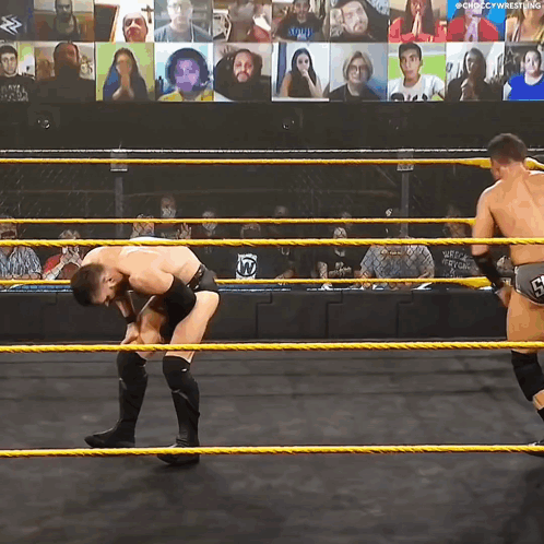 two wrestlers in a wrestling ring with a screen behind them that says ' chicago wrestling ' on it
