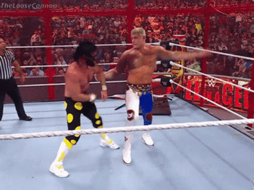two wrestlers in a wrestling ring with the loose cannon written on the side