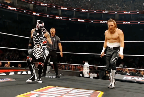 Two Wrestlers in Ring Saying Raw