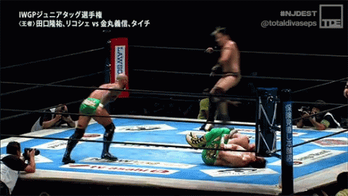 Two Wrestlers in Ring With Banco Sign