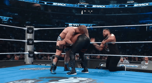 Two Wrestlers in Ring With Smack Sign
