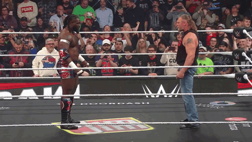 Two Wrestlers One in Punk Shirt