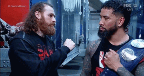 Two Wrestlers, One Wearing Wrestling Belt