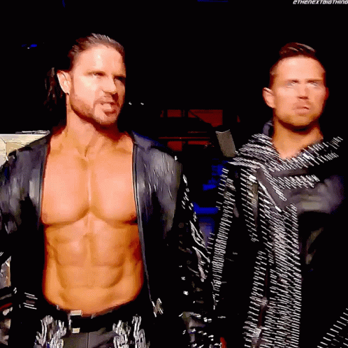 Two Wrestlers Standing in Dark Room Shirtless