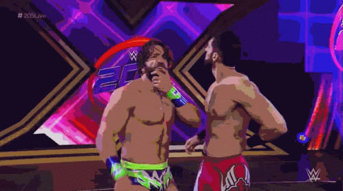 Two Wrestlers Standing Next to Each Other