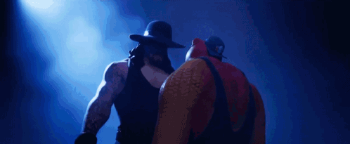 Two Wrestlers Standing Next to Each Other