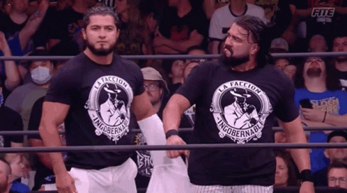 Two Wrestlers Wearing Black Shirts That Say La Facción GIF