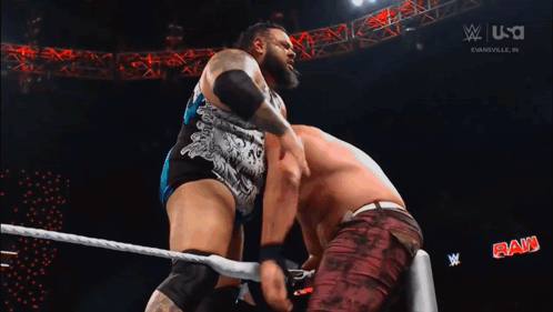 Two Wrestlers Wrestling in Ring With W