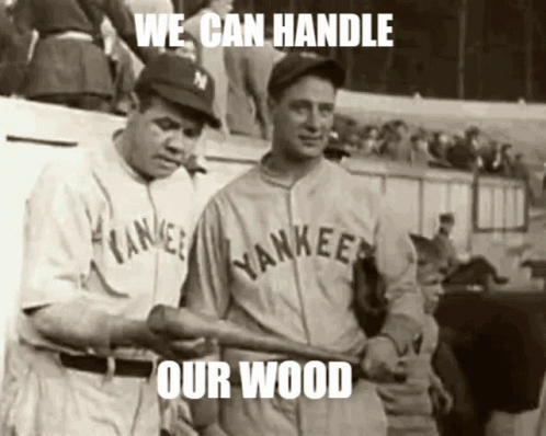 Two Yankees Baseball Players Holding Bat