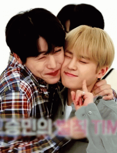 Two Young Men Are Hugging And One Of Them Is Kissing The Other 'S Cheek GIF