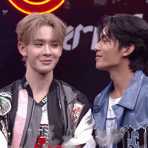 Two Men Standing, One With DTM Jacket GIF