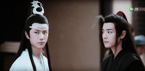 Two Young Men Are Standing Next To Each Other And One Of Them Is Wearing A White Robe GIF
