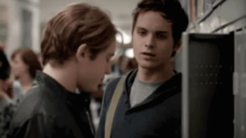 Two Young Men Standing In Locker Room GIF