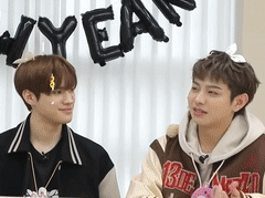 Two Young Men Beside New Year Sign
