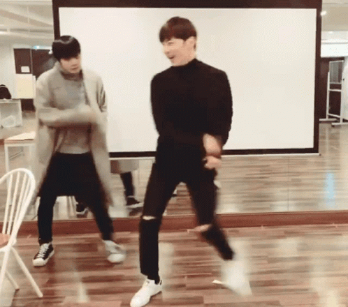 Two Young Men Dancing in Front of Mirror