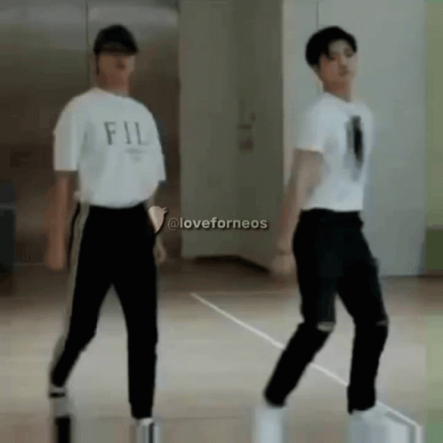Two Young Men Dancing, One In FIL Shirt GIF