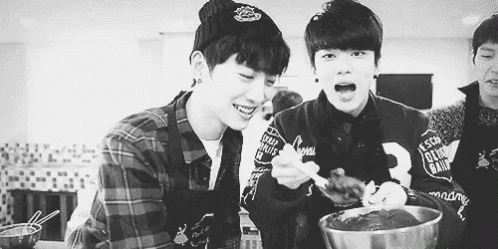 Two Young Men Eating in Kitchen