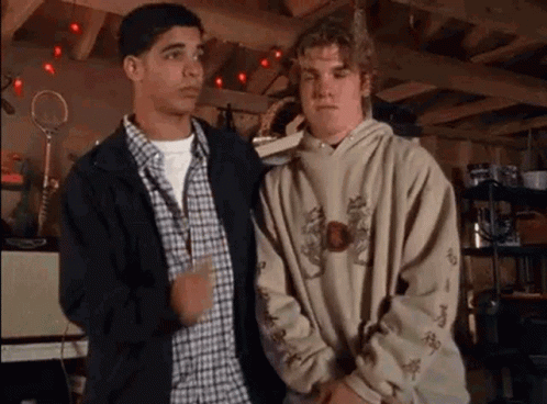 Two Young Men in Garage, One in Hoodie