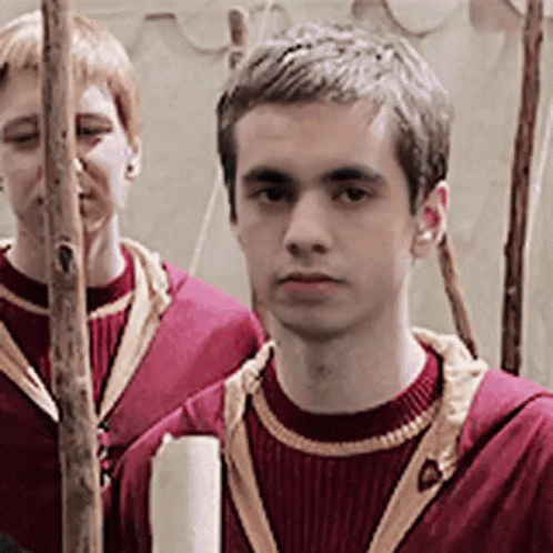 Two Young Men in Red Sweaters Standing Together