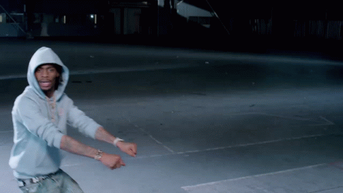 Two Young Men Laughing In Front Of Popsugar Flag At Comic Con GIF