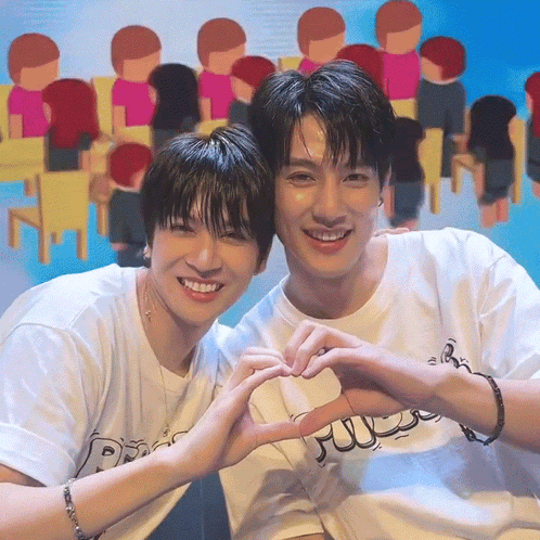 Two Young Men Making A Heart Shape With Their Hands In Front Of A Crowd GIF